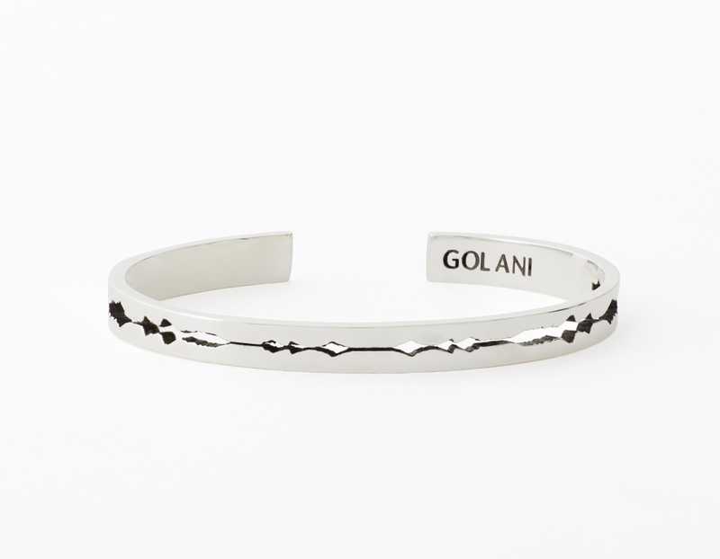 The Cut Wave Bracelet placed horizontal in Antiqued Sterling Silver